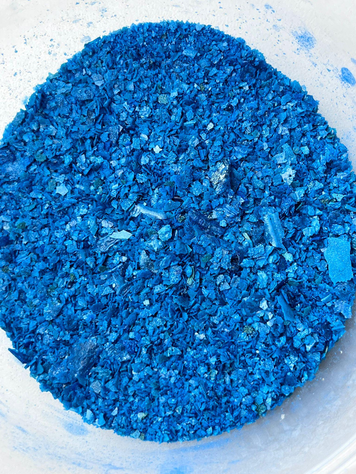 Dark blue edible wafer paper glitter flakes shown close up for cake and dessert decoration.