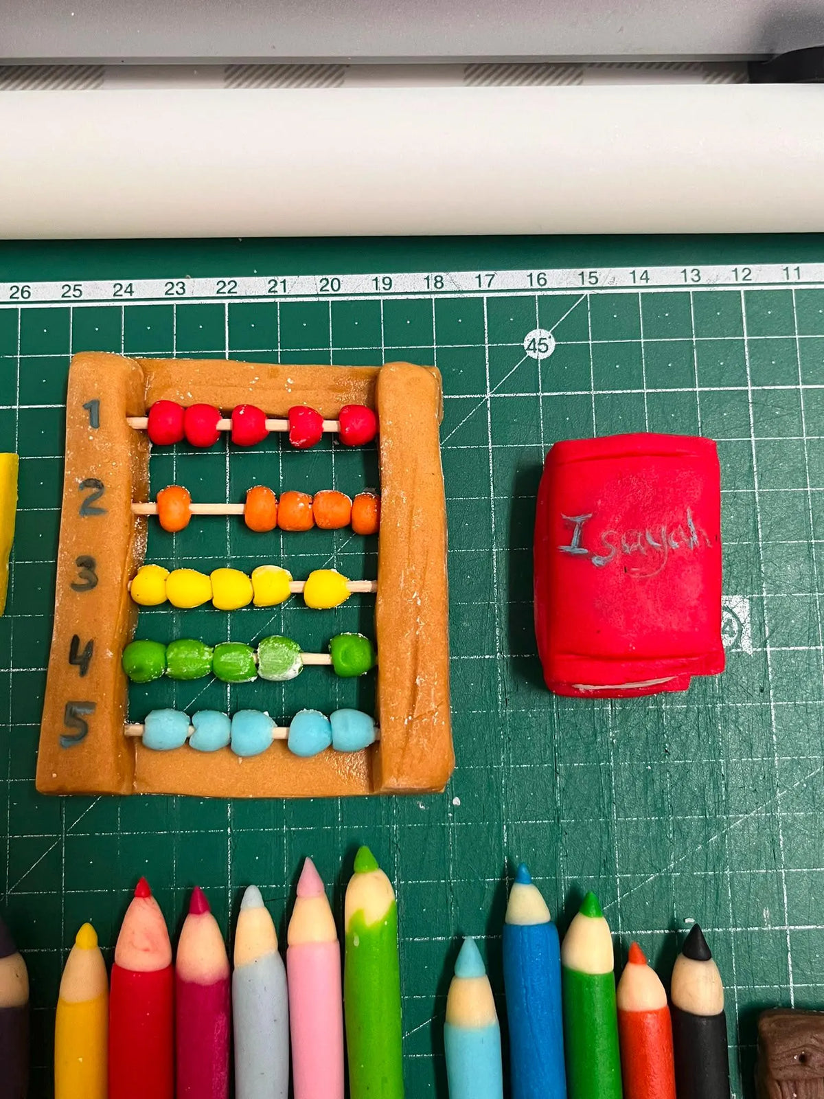 Handmade edible school-themed fondant cake decoration, image 5.