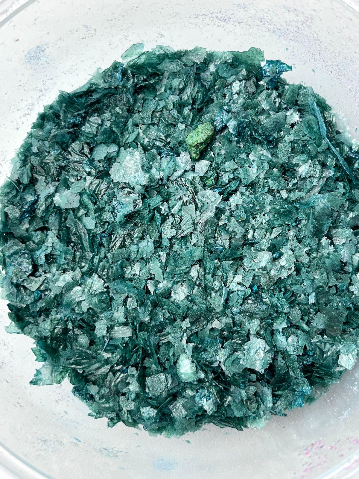 Green edible wafer paper glitter flakes shown close up for cake and dessert decoration.