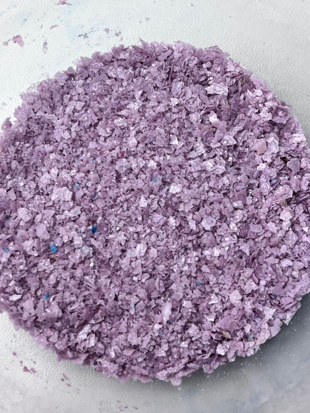Lilac edible wafer paper glitter flakes shown close up for cake and dessert decoration.