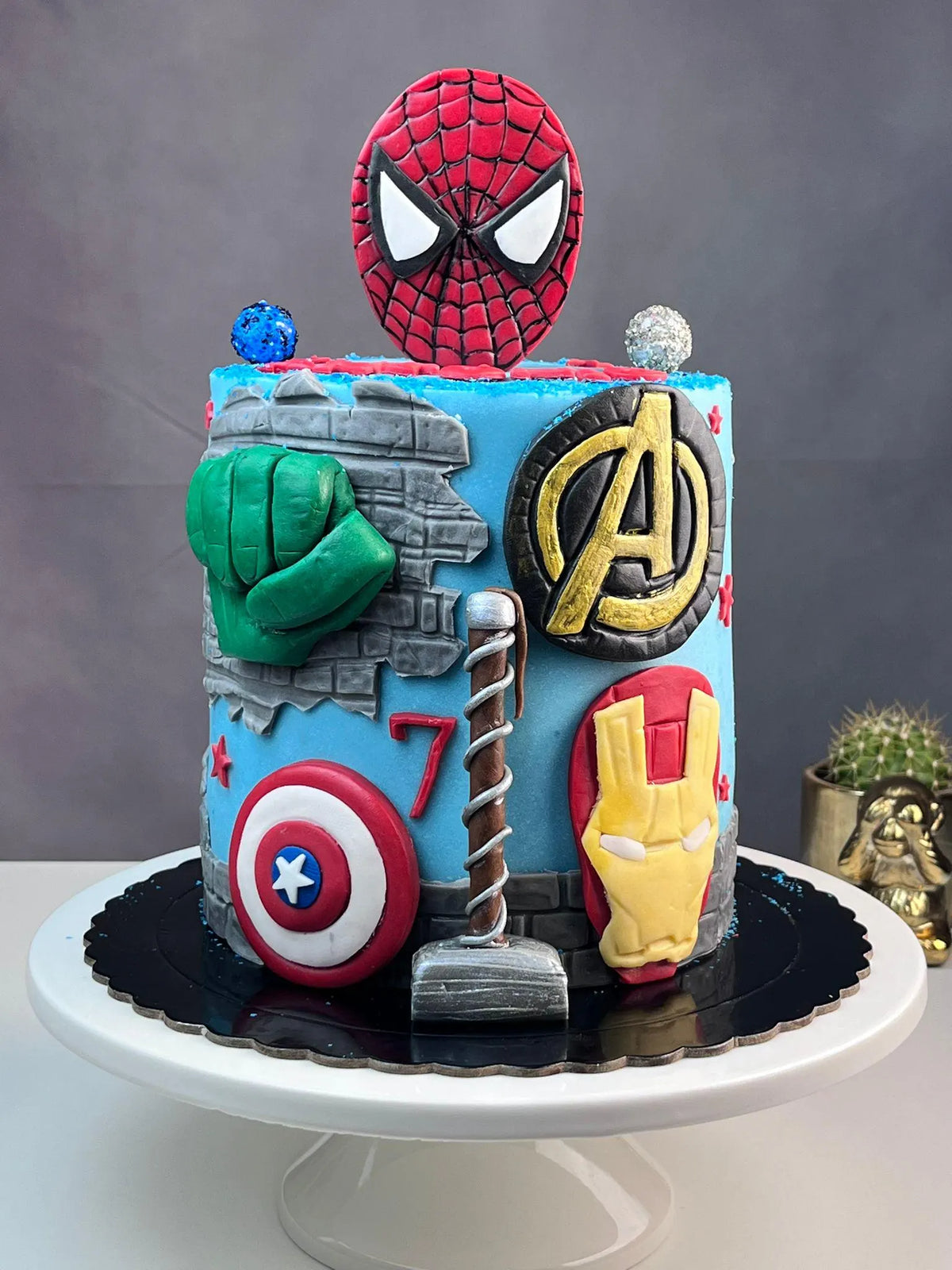 Handmade edible superhero fondant cake decoration, image 1.
