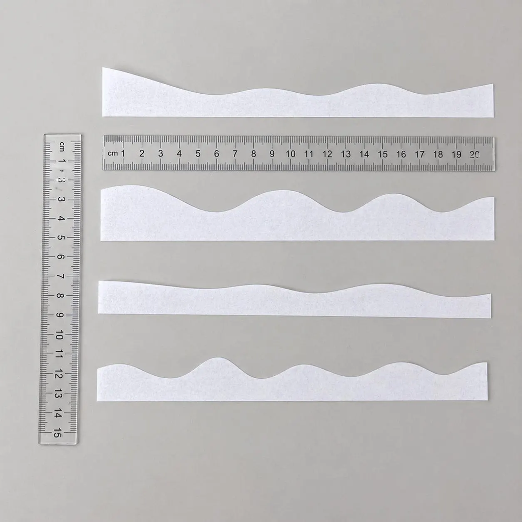 Precut edible wafer paper ruffles for decorating wedding and celebration cakes.