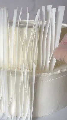 Precut wafer paper ruffle decorations for elegant cake designs.