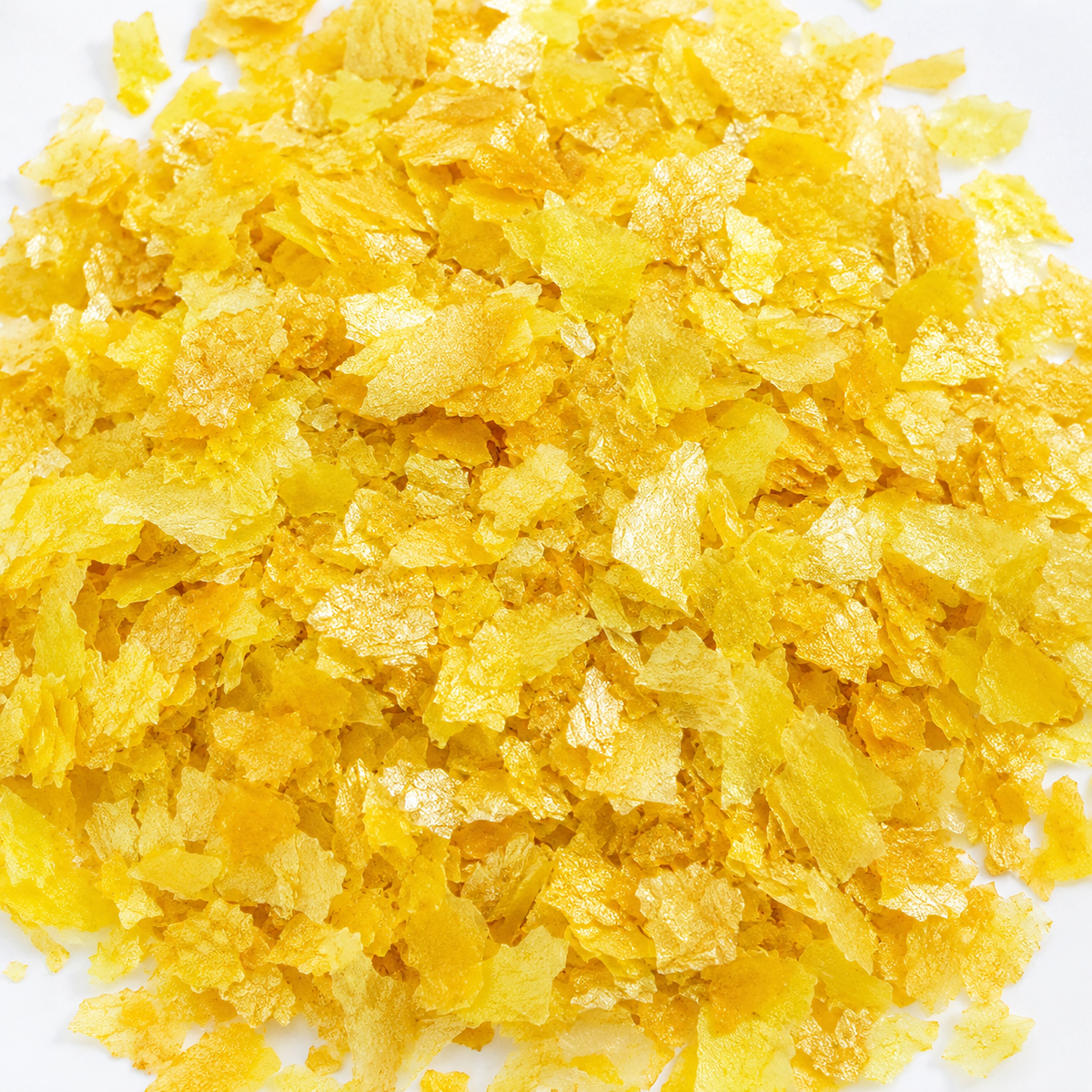 Yellow edible wafer paper glitter flakes shown close up for cake and dessert decoration.
